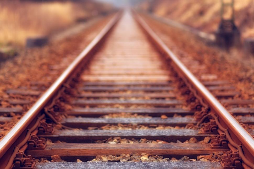 Free Image of Rusty railway tracks stretching into the blurred distance. 