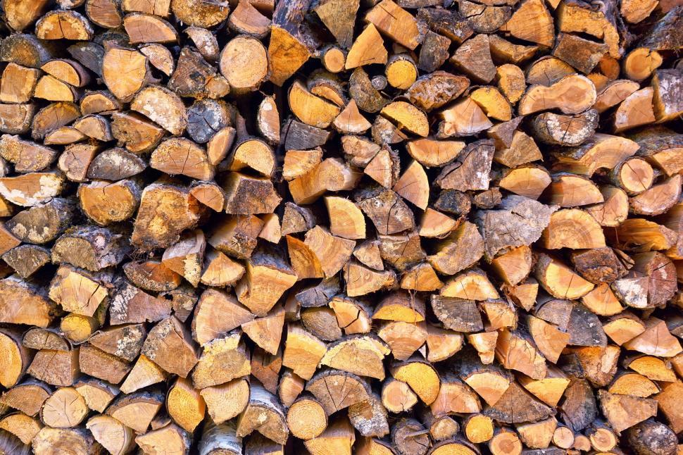 Free Image of Stacked firewood showing texture with varied colors 
