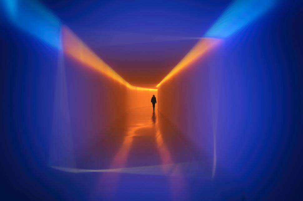 Free Image of Person walking through a vibrant, futuristic tunnel. 