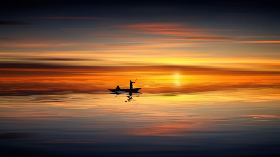 Free Image of Silhouette of two people kayaking at sunset on lake. 