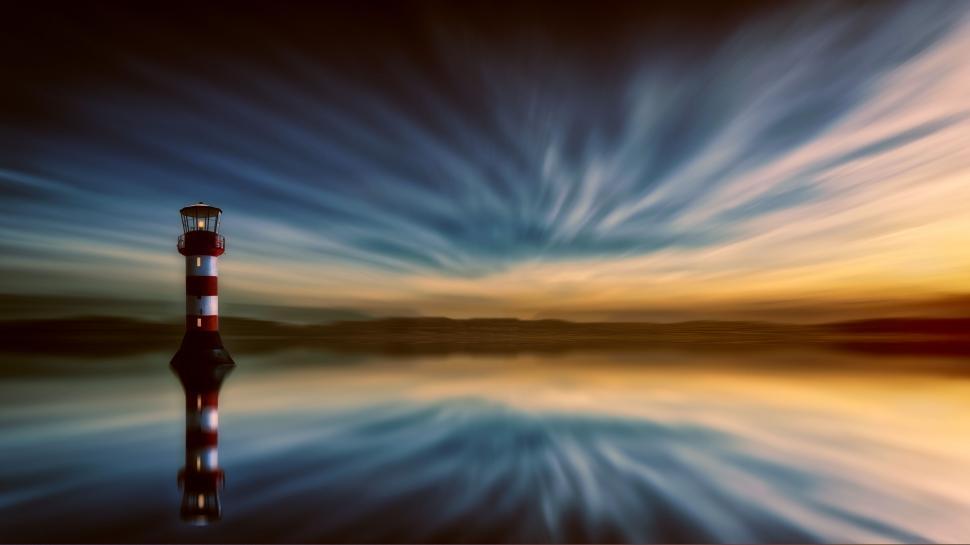 Free Image of Lighthouse under dynamic sky reflecting on water 