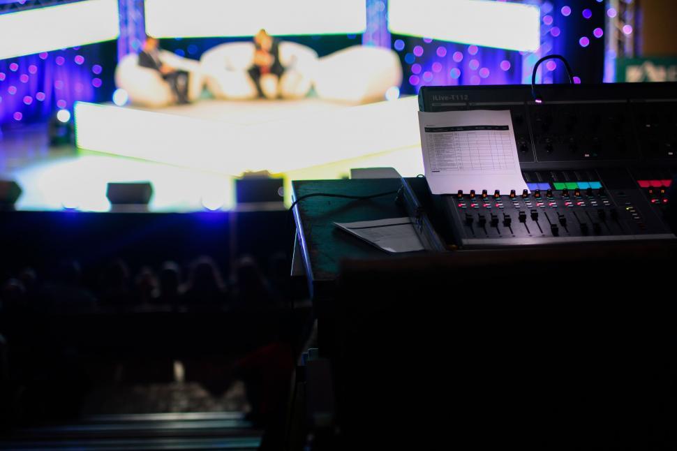 Free Image of Control panel of sound system in a dimly lit studio 