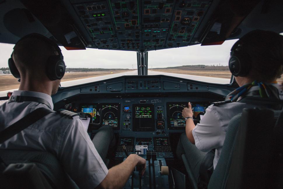 Free Image of Cockpit view with two pilots during flight takeoff 