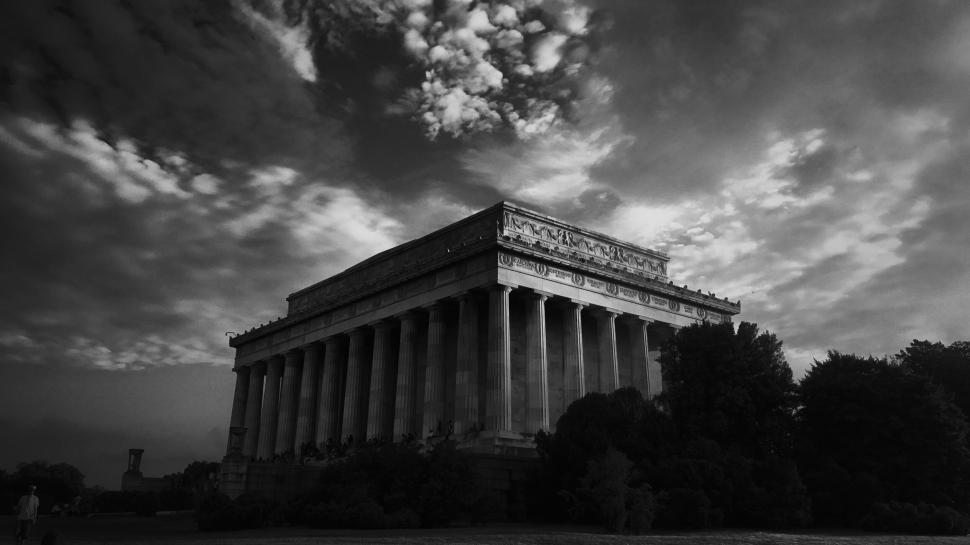 Free Image of Historic building with columns under dramatic cloudy sky. 