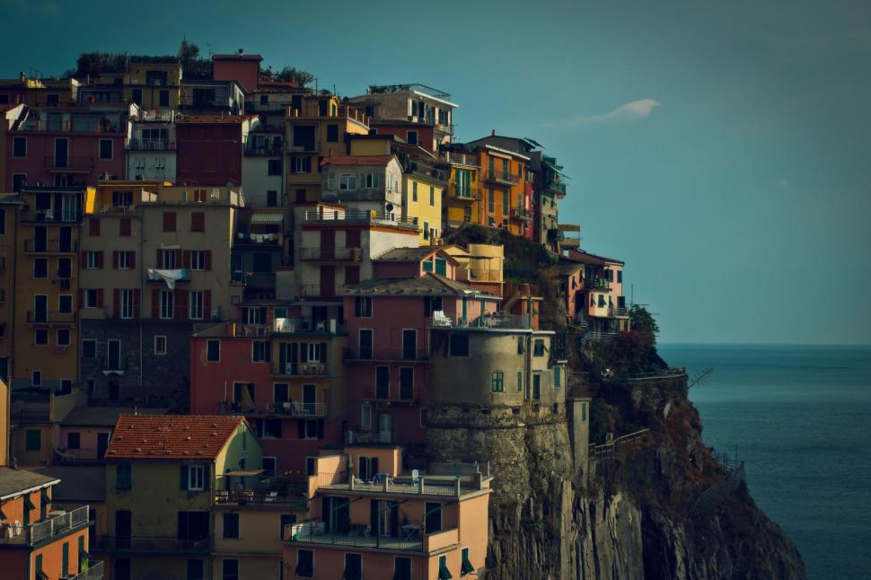 Free Image of Colorful seaside village buildings perched on cliff 