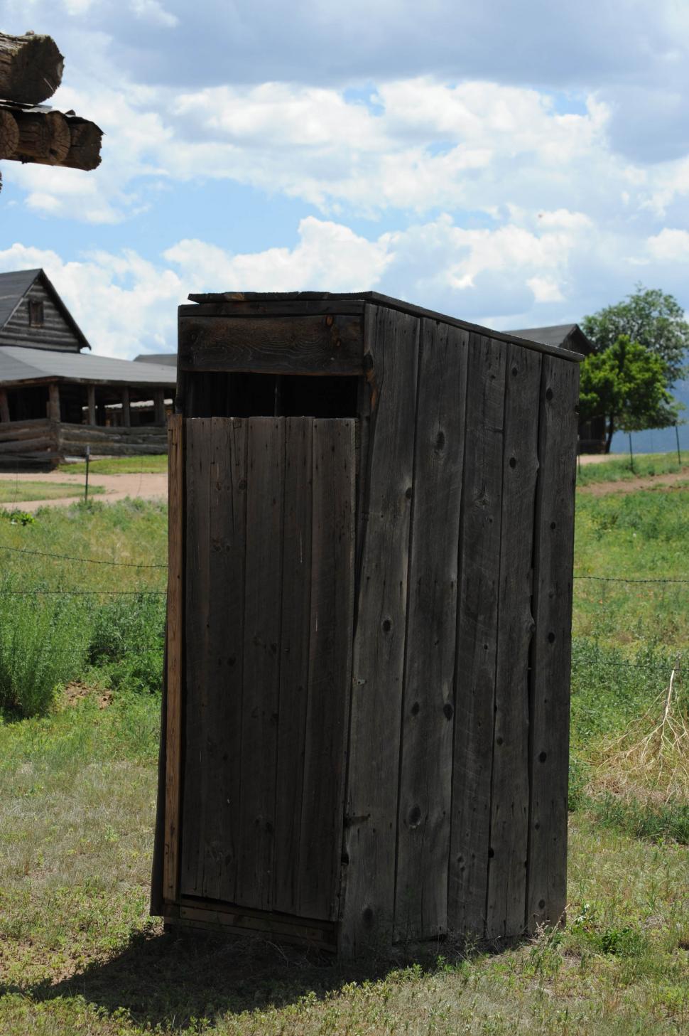 Free Image of Outhouse and Wooden Cabin with Green Grass 