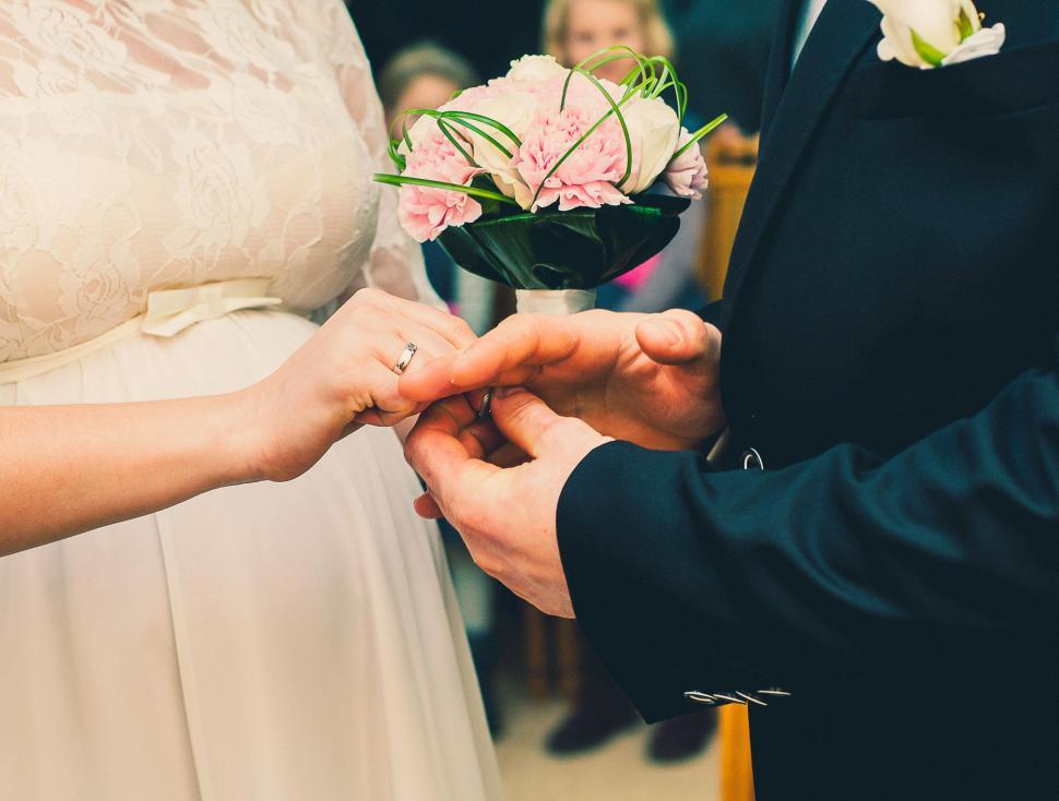 Bride and groom exchange rings during their wedding ceremony