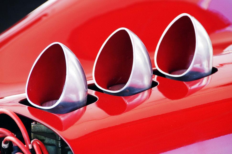 Free Image of Close Up of Red Car With Three Exhaust Pipes 