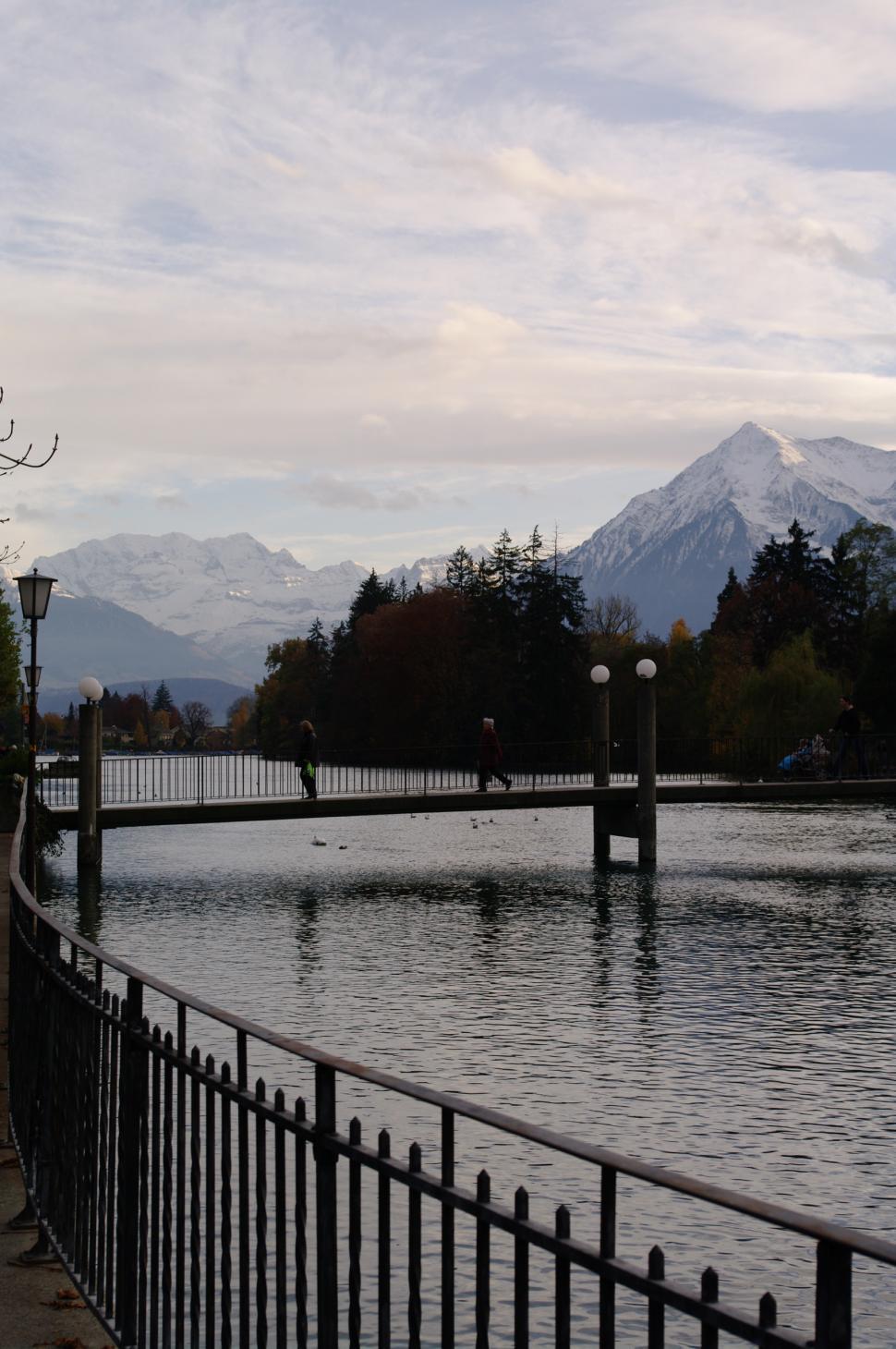 Free Image of Bridge Crossing Over Water With Mountains in Background 