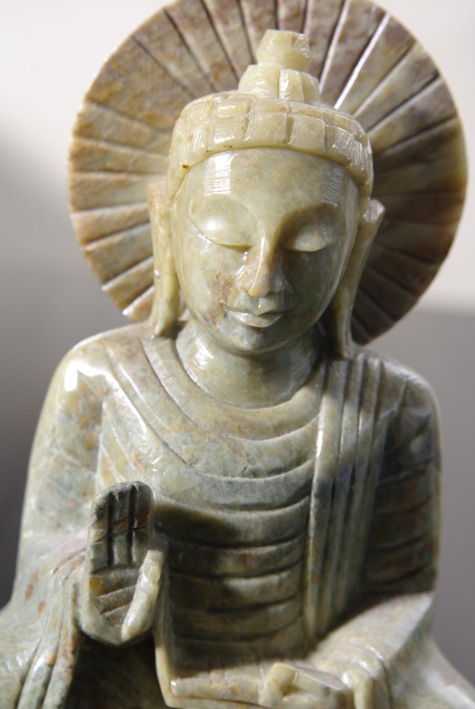 Free Image of Statue of a Seated Buddha Holding a Book 
