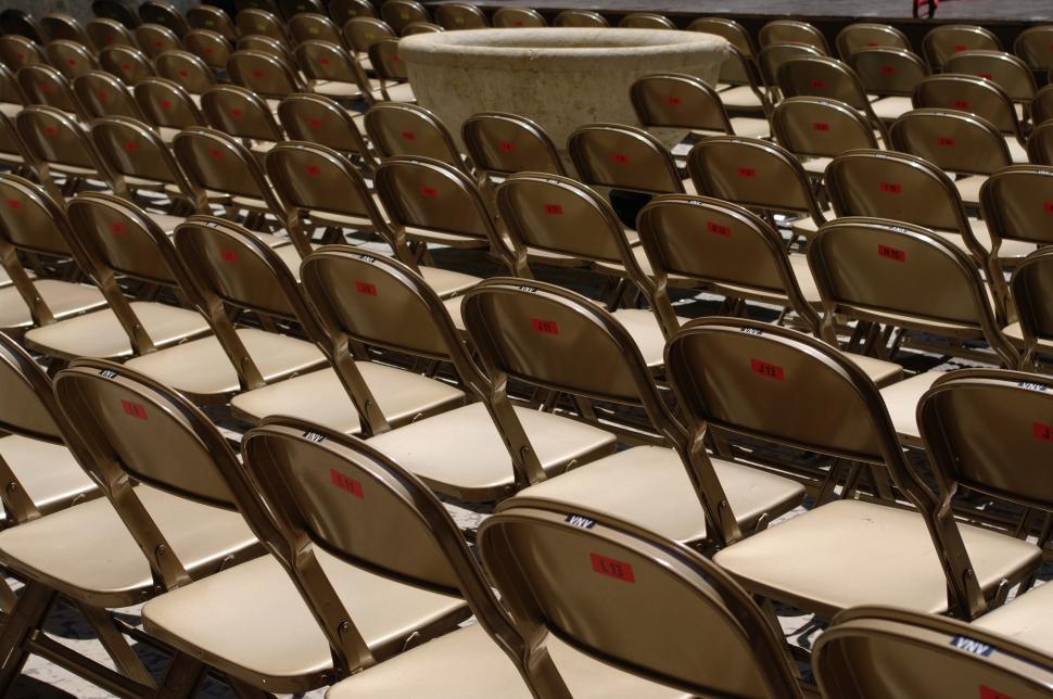 Free Image of Rows of Empty Chairs With Red Marks 
