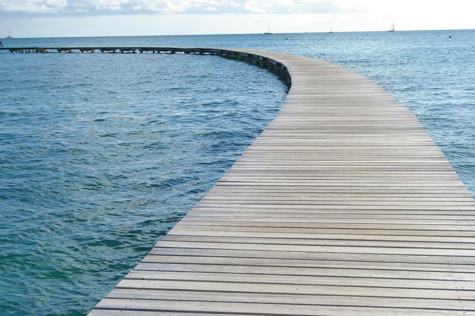 Free Image of Wooden Pier Extending Into the Ocean 