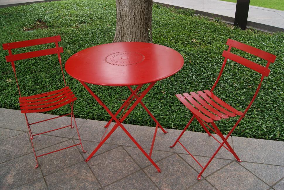 Free Image of Red Chairs and table in the garden  