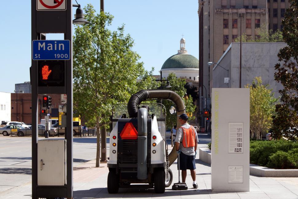 Free Image of Man Standing Next to Machine on City Street 