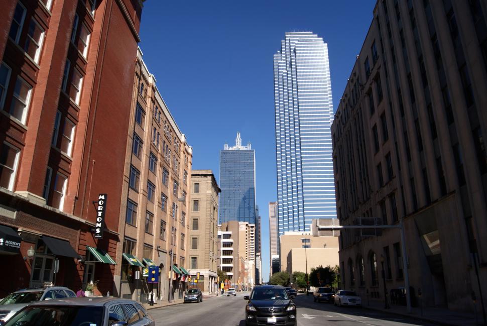Free Image of  Skyscrapers of  Dallas, Texas skyline during the day with vehicle traffic driving  
