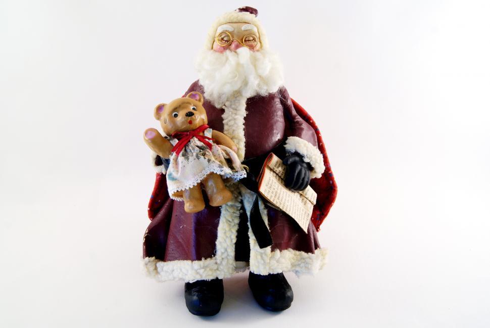 Free Image of Santa Figurine Holding Teddy Bear 
