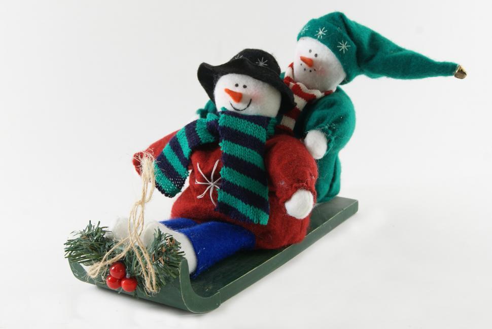 Free Image of Two Snowmen Sitting on a Sled 
