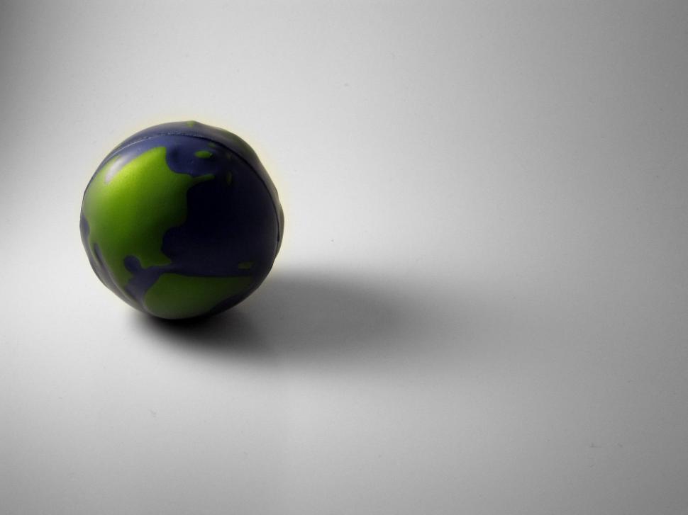 Free Image of Green and Black Ball on Gray Background 