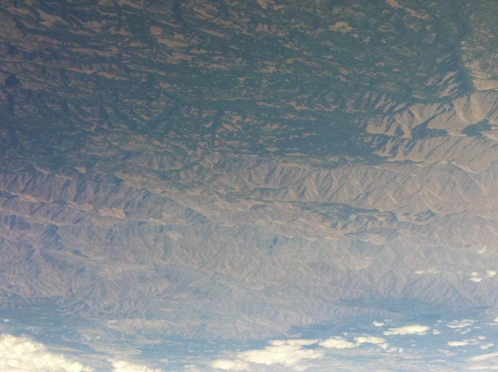 Free Image of Plane Flying Over Mountain Range in the Sky 