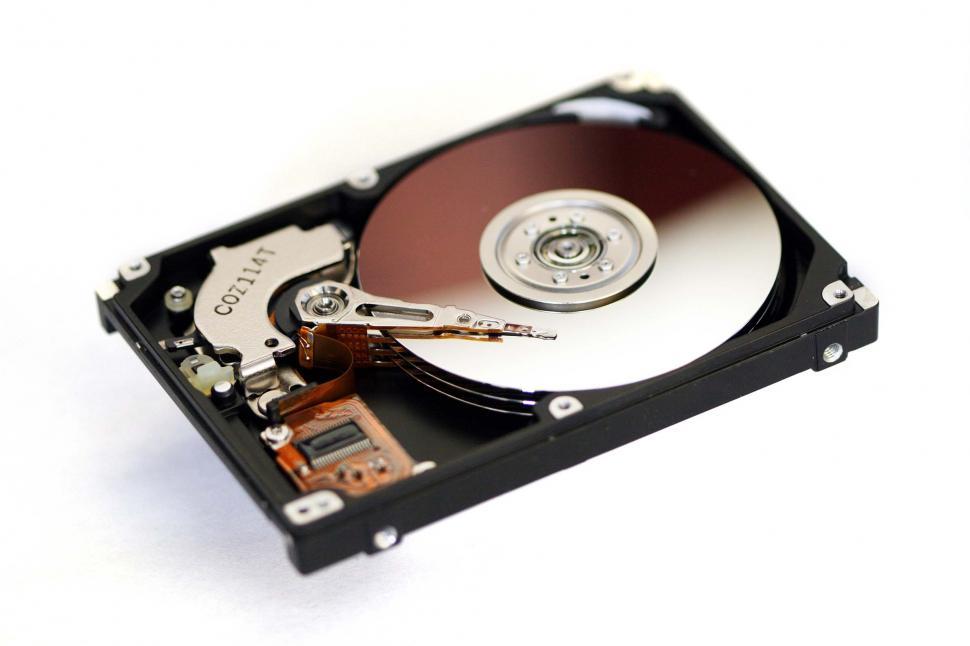Free Image of hard drives mechanisms computers electronics storage disks hardware megabytes platters mirrored spinning technology high-tech gigabytes information components innards insides shiney arm sensor peripherals parts mechanical precise precision 