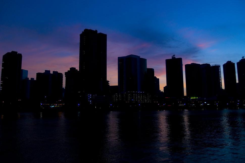 Free Image of City Skyline Illuminated Across Water at Night 