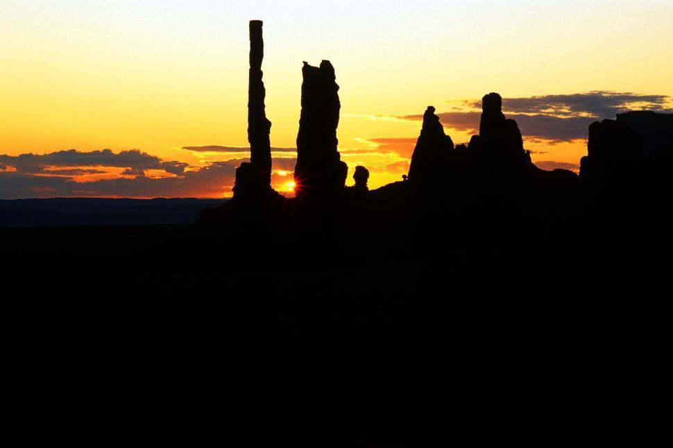 Free Image of monument valley rocks formations erosion geologic sunsets four corners cliffs mesas dunes desert landscapes desolate reservations sand red navajo silhouettes sundown sun golden sky dramatic 