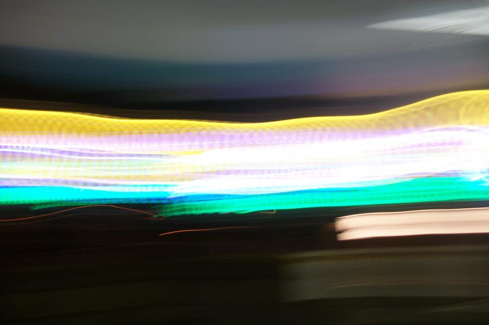 Free Image of Blurry Car Driving Down Street 