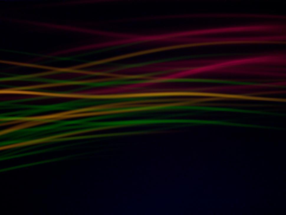Free Image of Blurry Black Background With Red, Green, and Yellow Lines 