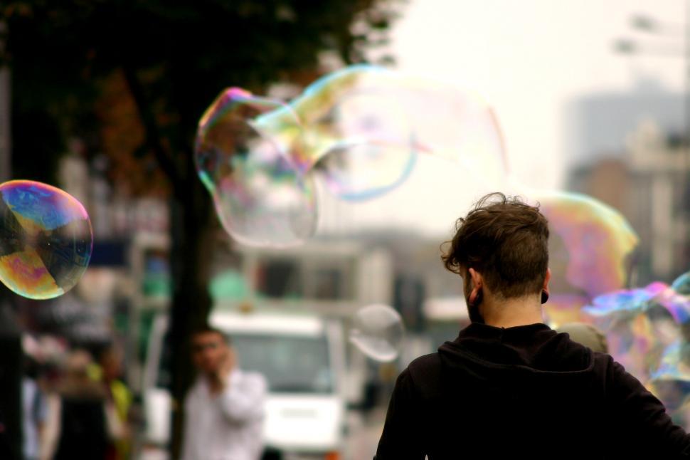 Free Image of Man Walking in Bubbles 