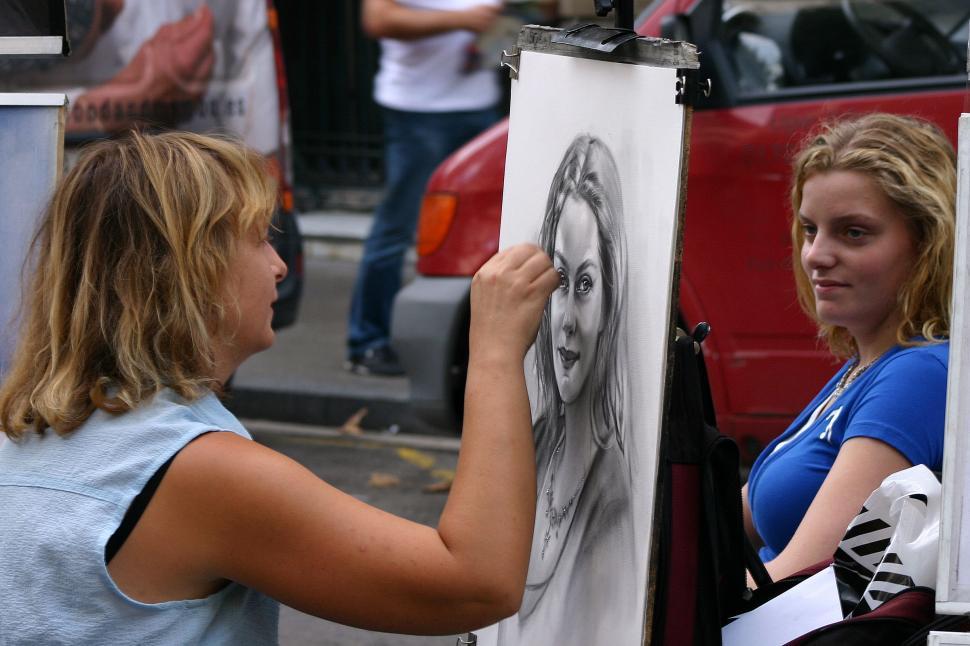 Free Image of Woman Drawing Picture on Canvas 