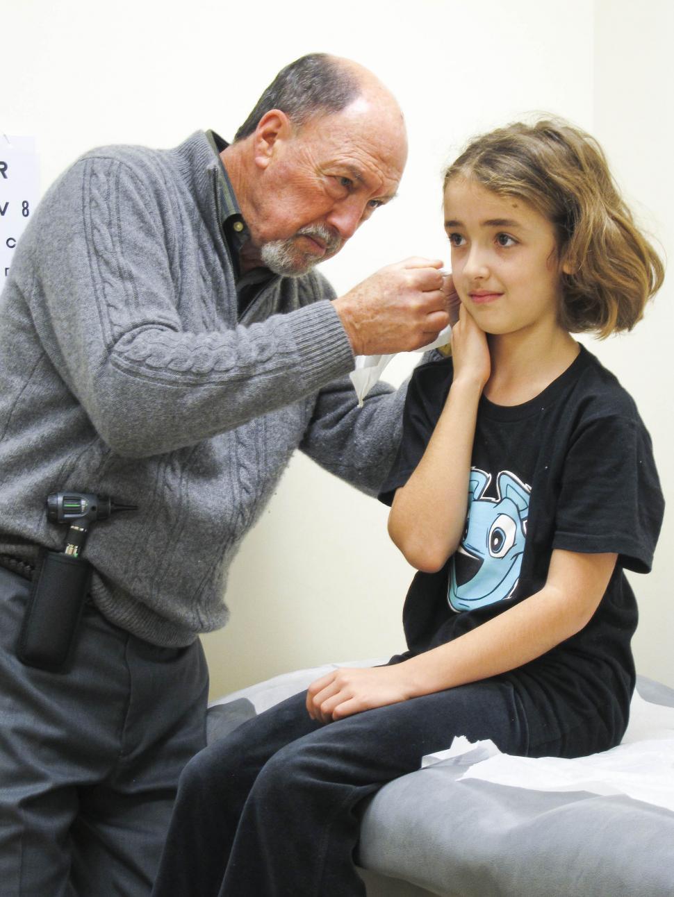 Free Image of Doctor check Child's ear 