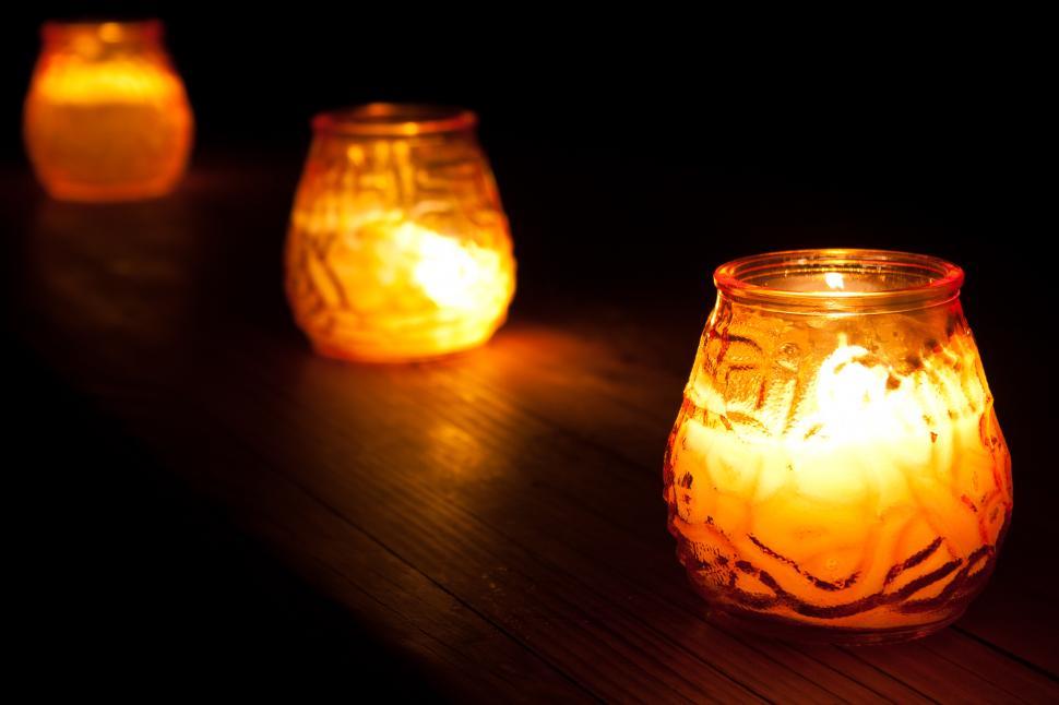 Free Image of Group of Lit Candles on Wooden Table 