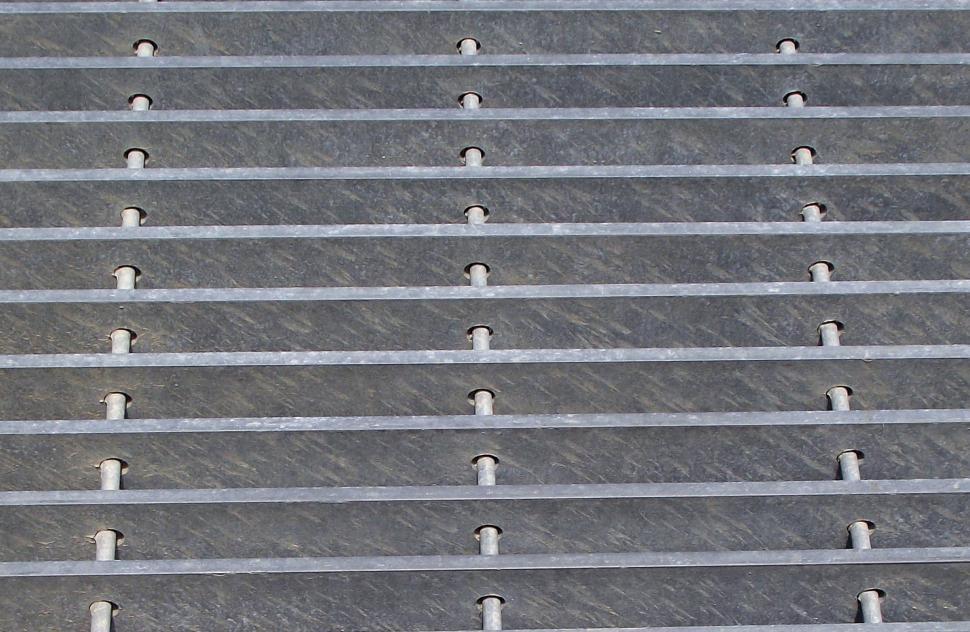 Free Image of steel drain grate along side of highway 