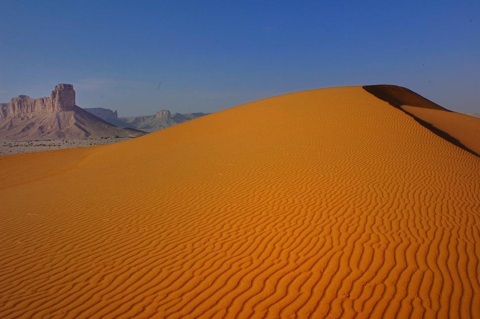 Free Image of Sand Dune With Mountain in Background 