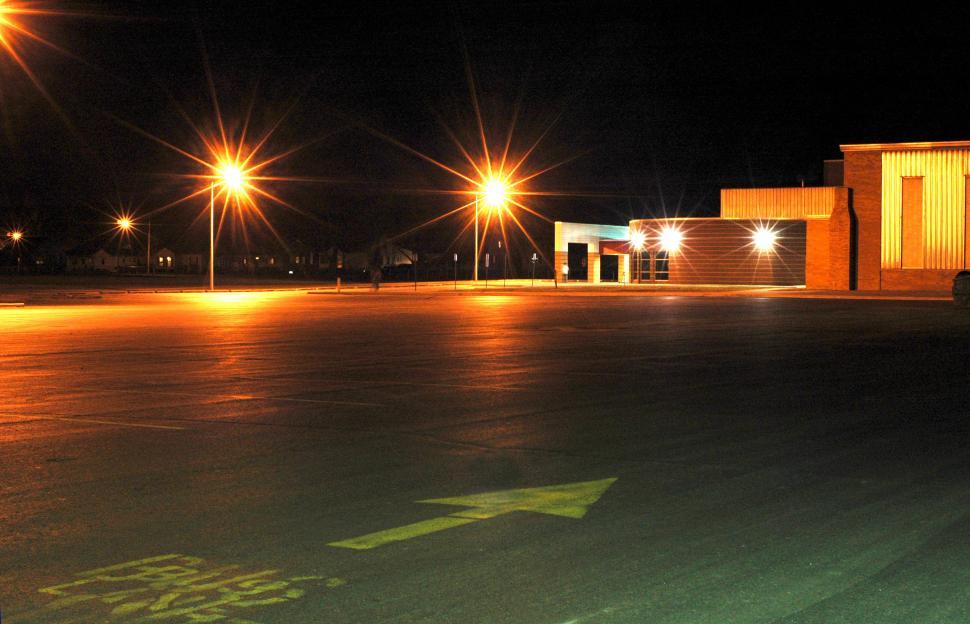 Free Image of Empty Parking Lot at Night With Lights On 