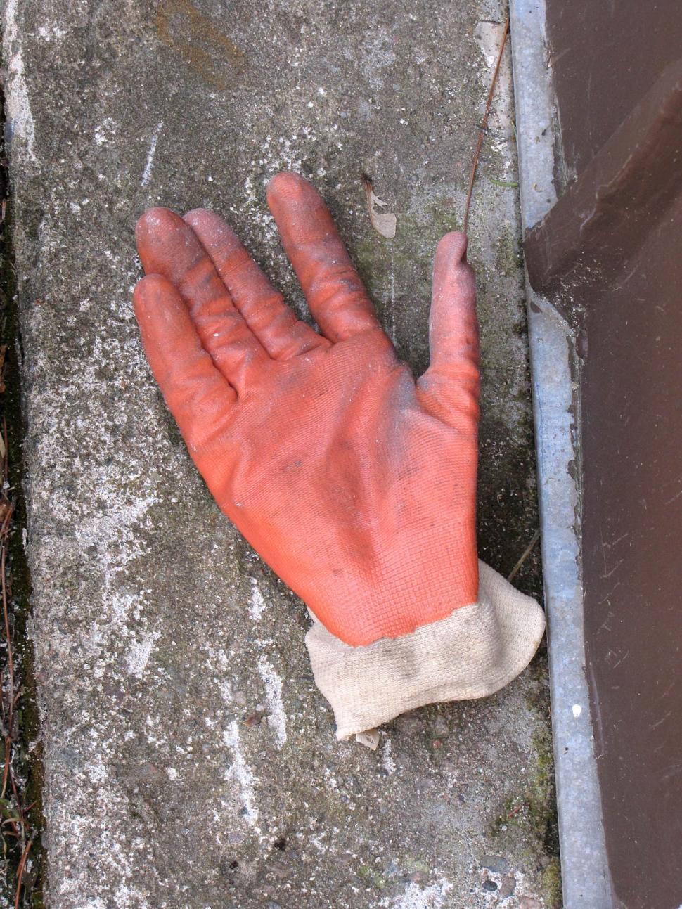 Free Image of Discarded Glove Near Trash Can 