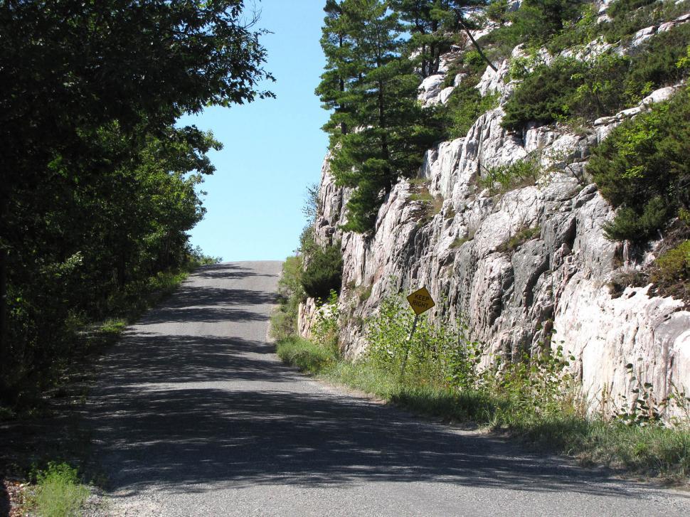 Free Image of Paved Road Surrounded by Trees and Rocks 
