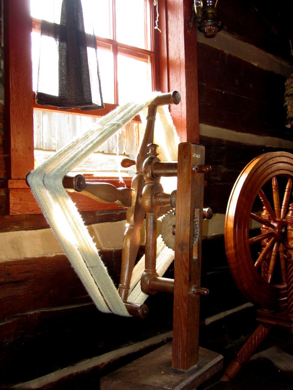 Free Image of Spinning Wheel in Front of Window 