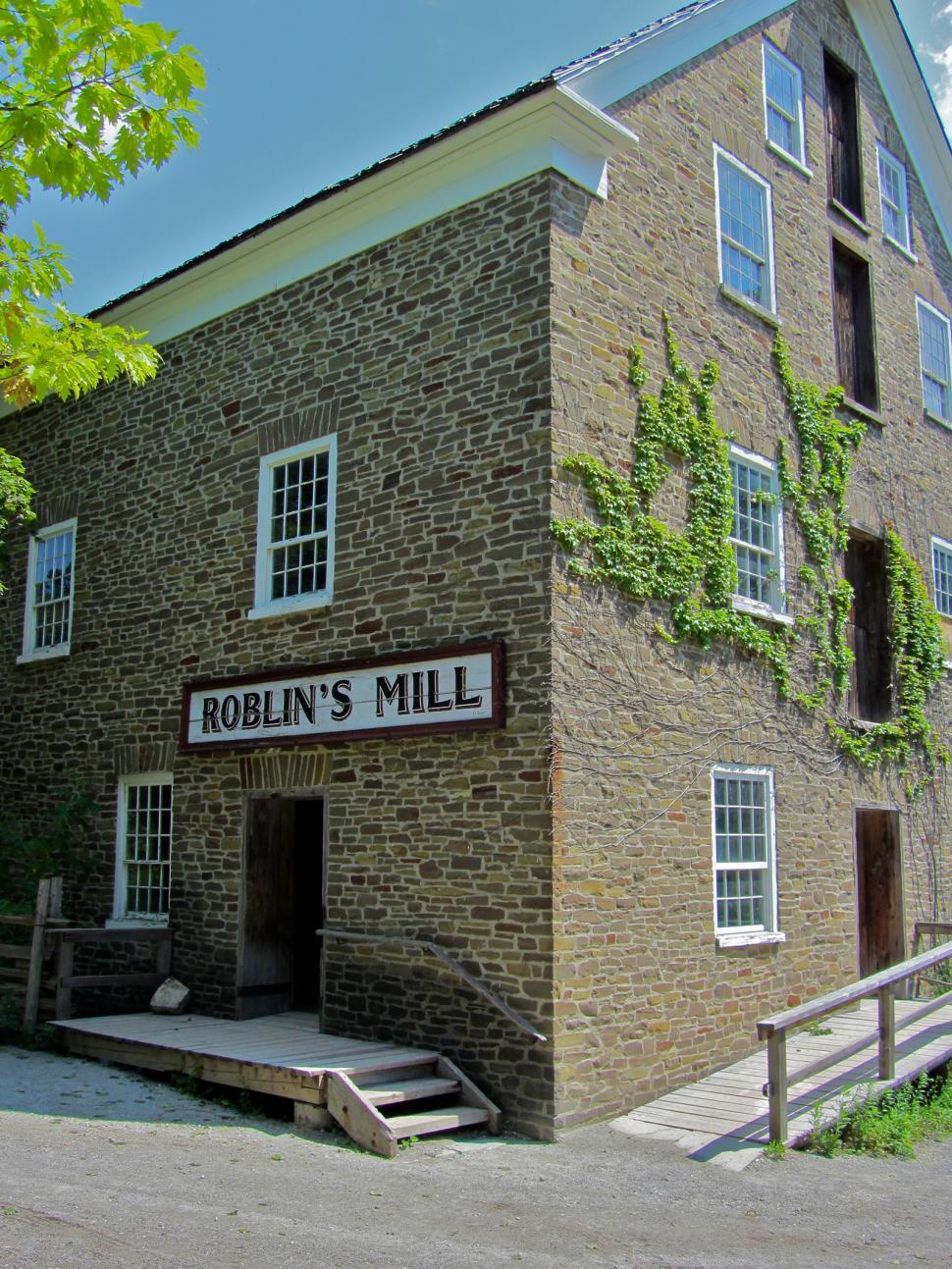 Free Image of Brick Building With a Sign for Robins Mill 