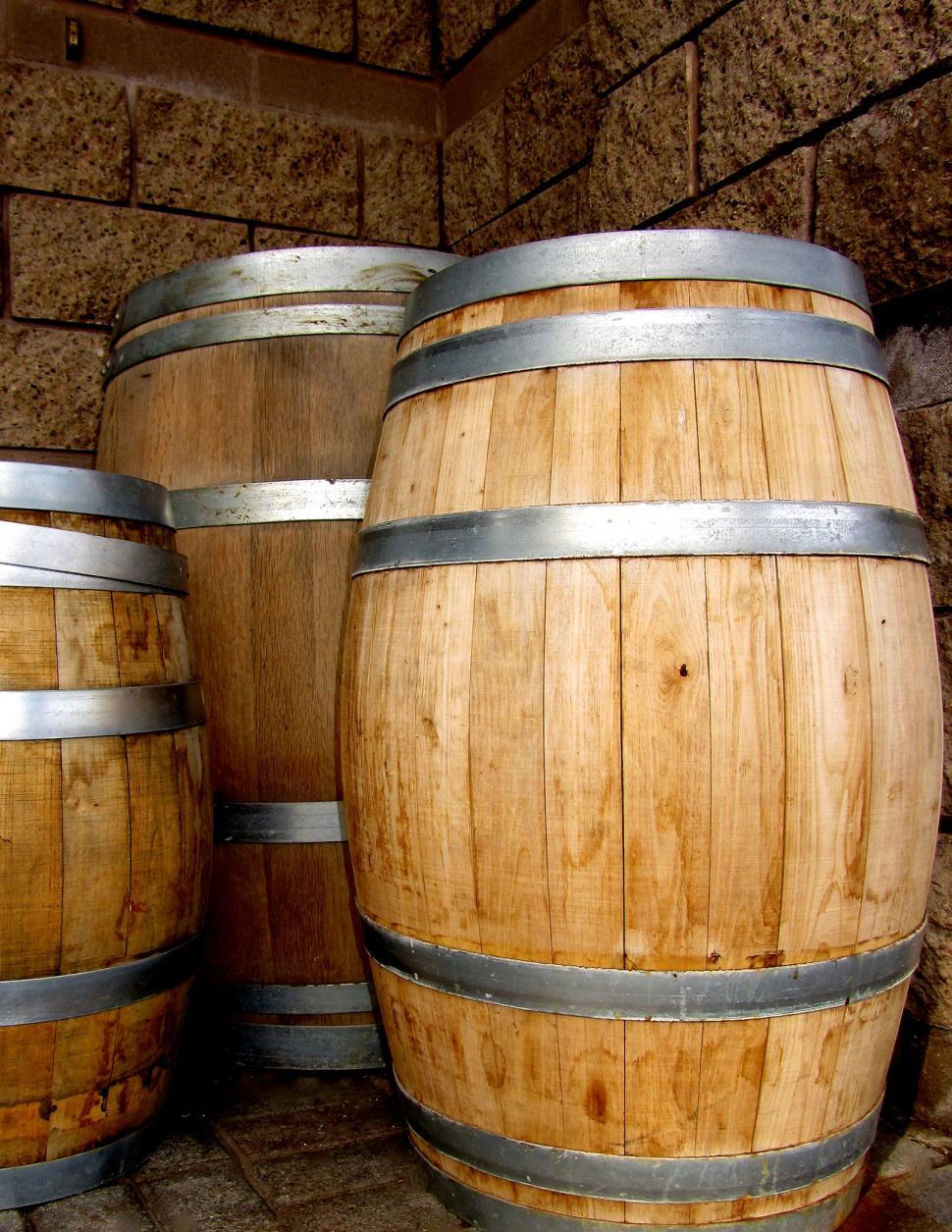 Free Image of Three Wooden Barrels Aligned Together 