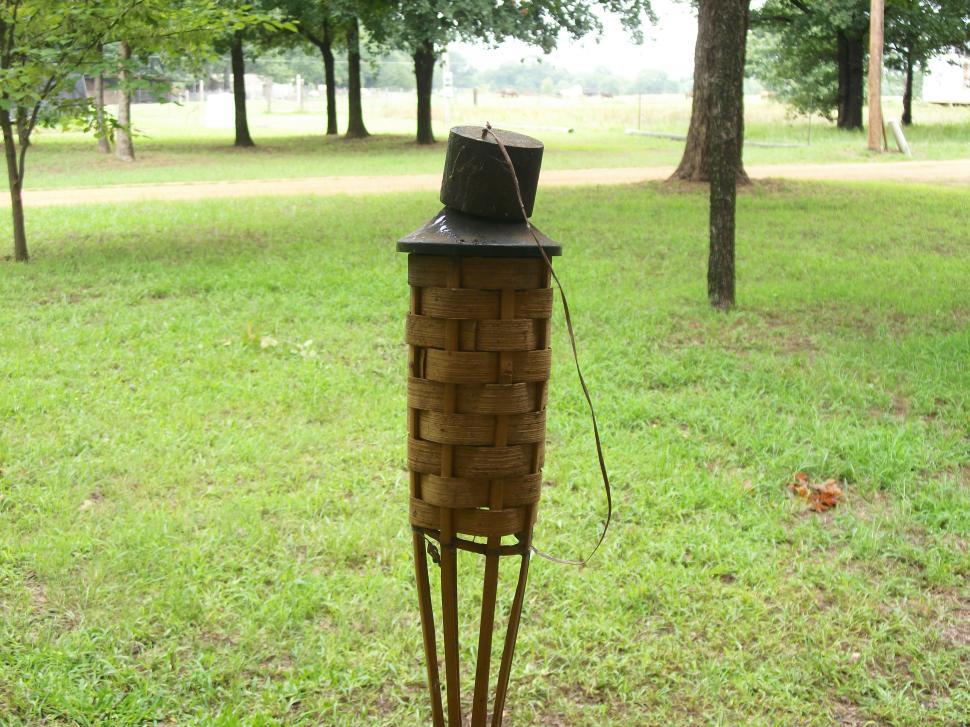 Free Image of Hat Resting on Wooden Post in Field 