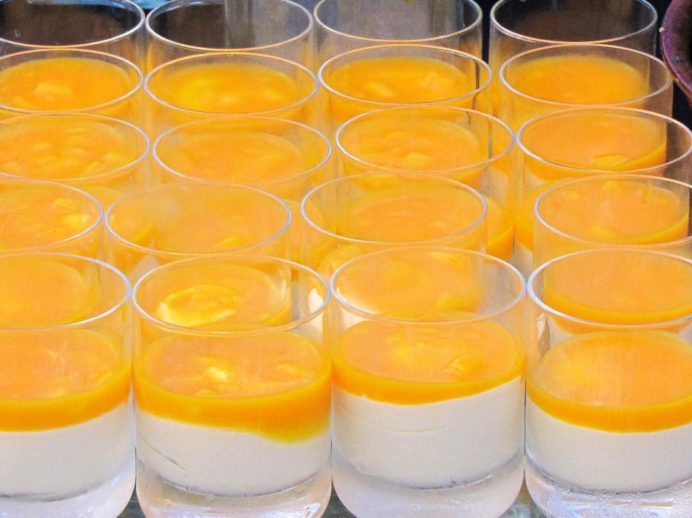 Free Image of Glasses of Yellow Liquid on Display 