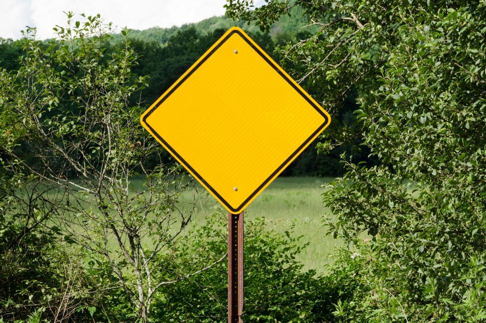 Free Image of Blank Road Sign with Meadow in Background 