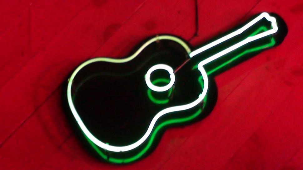 Free Image of Neon Guitar on red wall 
