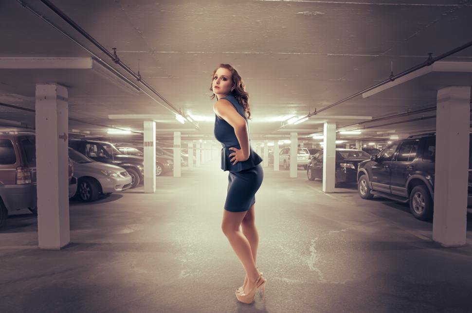 Free Image of Woman poses in parking garage 