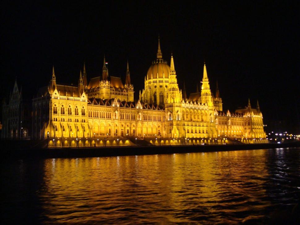 Free Image of Stunning Building Illuminated at Night by Water 