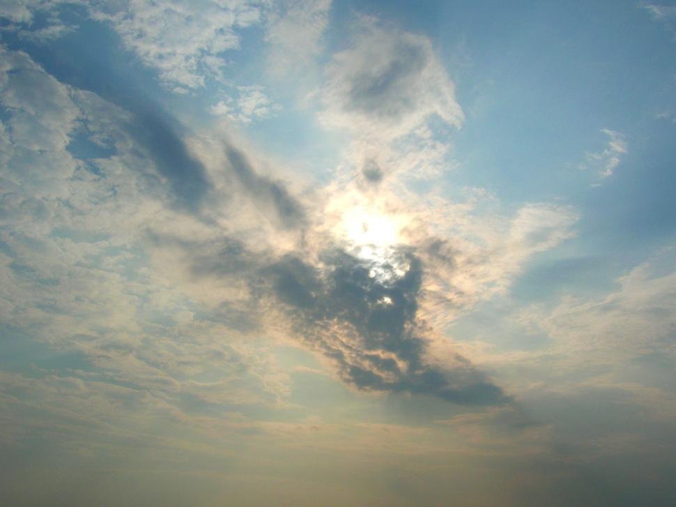 Free Image of Sun Shining Through Clouds in the Sky 