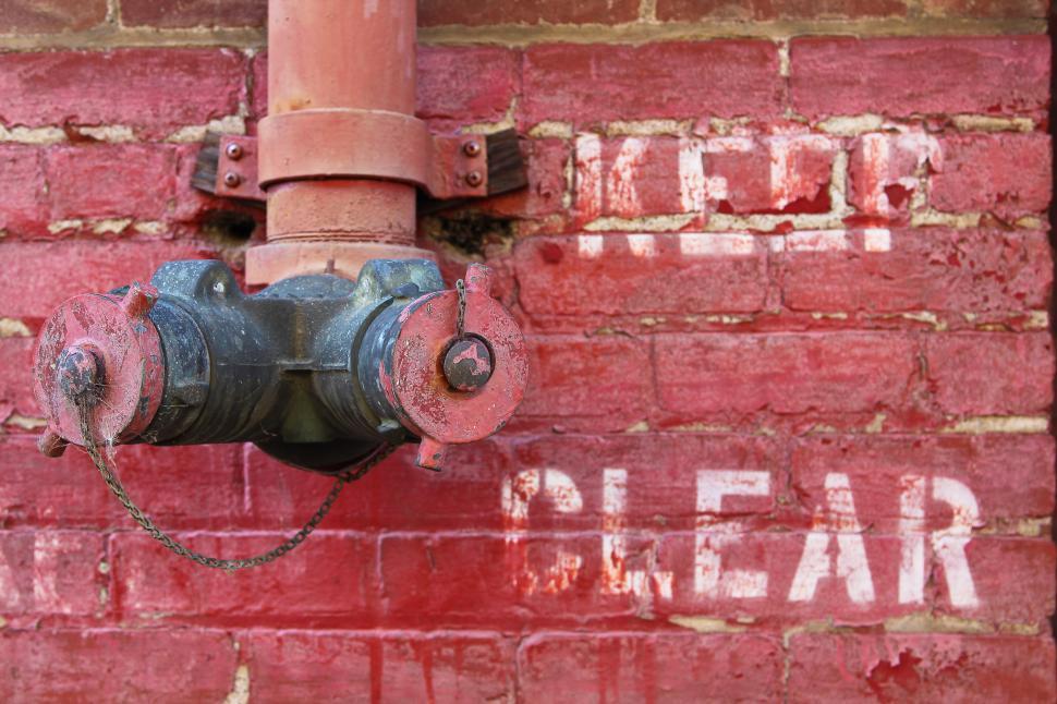 Download Free Stock Photo of Fire Hydrant on a Wall 