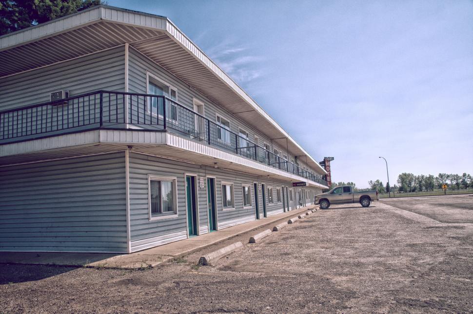 Free Image of Motel Building With Parked Car 