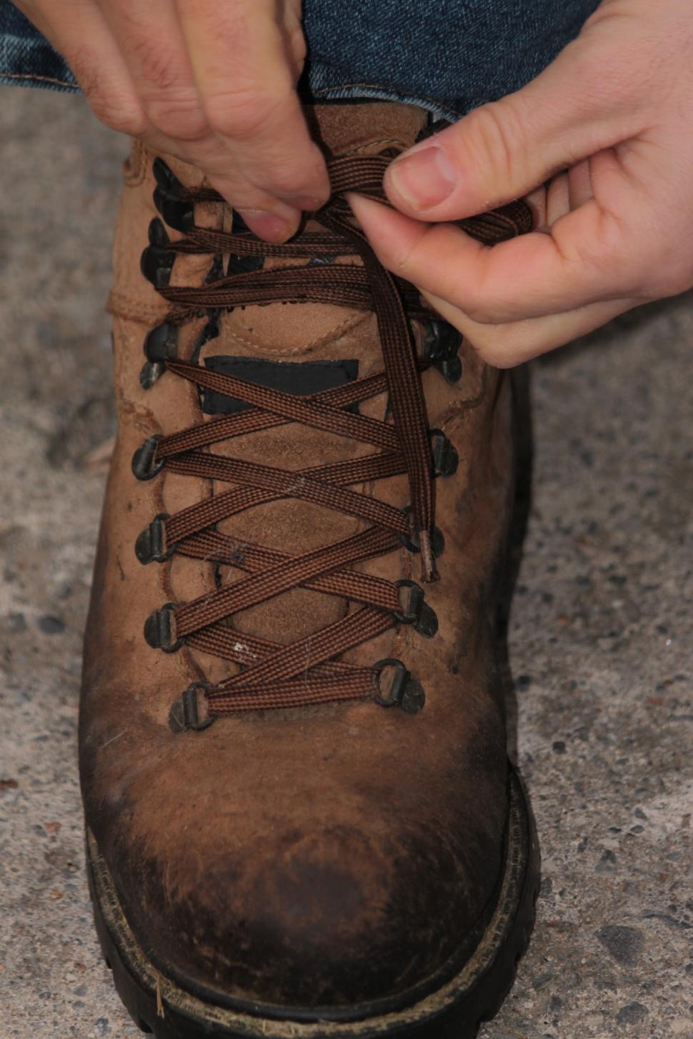 Free Image of Tying work boots 